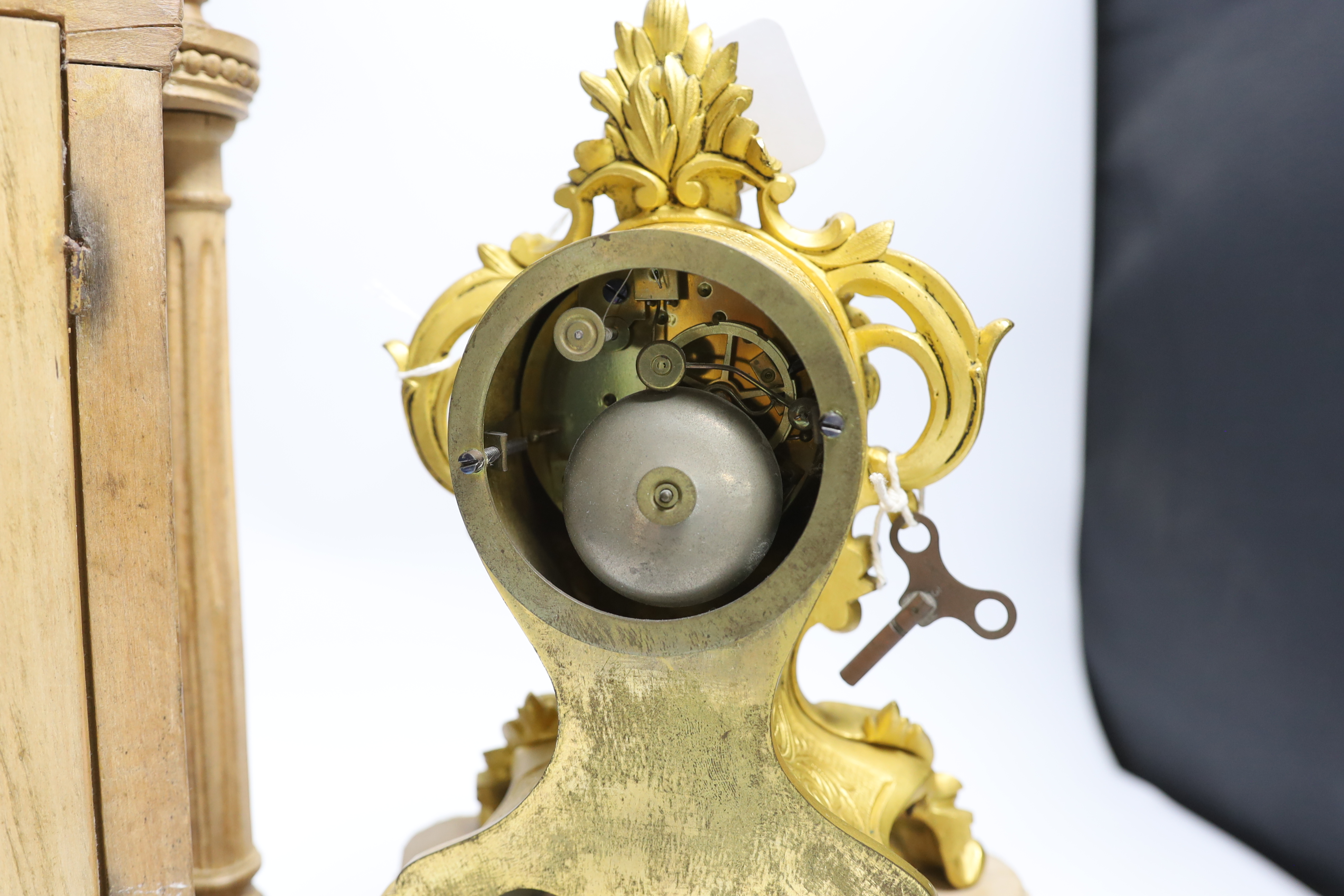 A late 19th century French carved blonde wood mantel clock and similar gilt metal mantel clock. Tallest 45cm